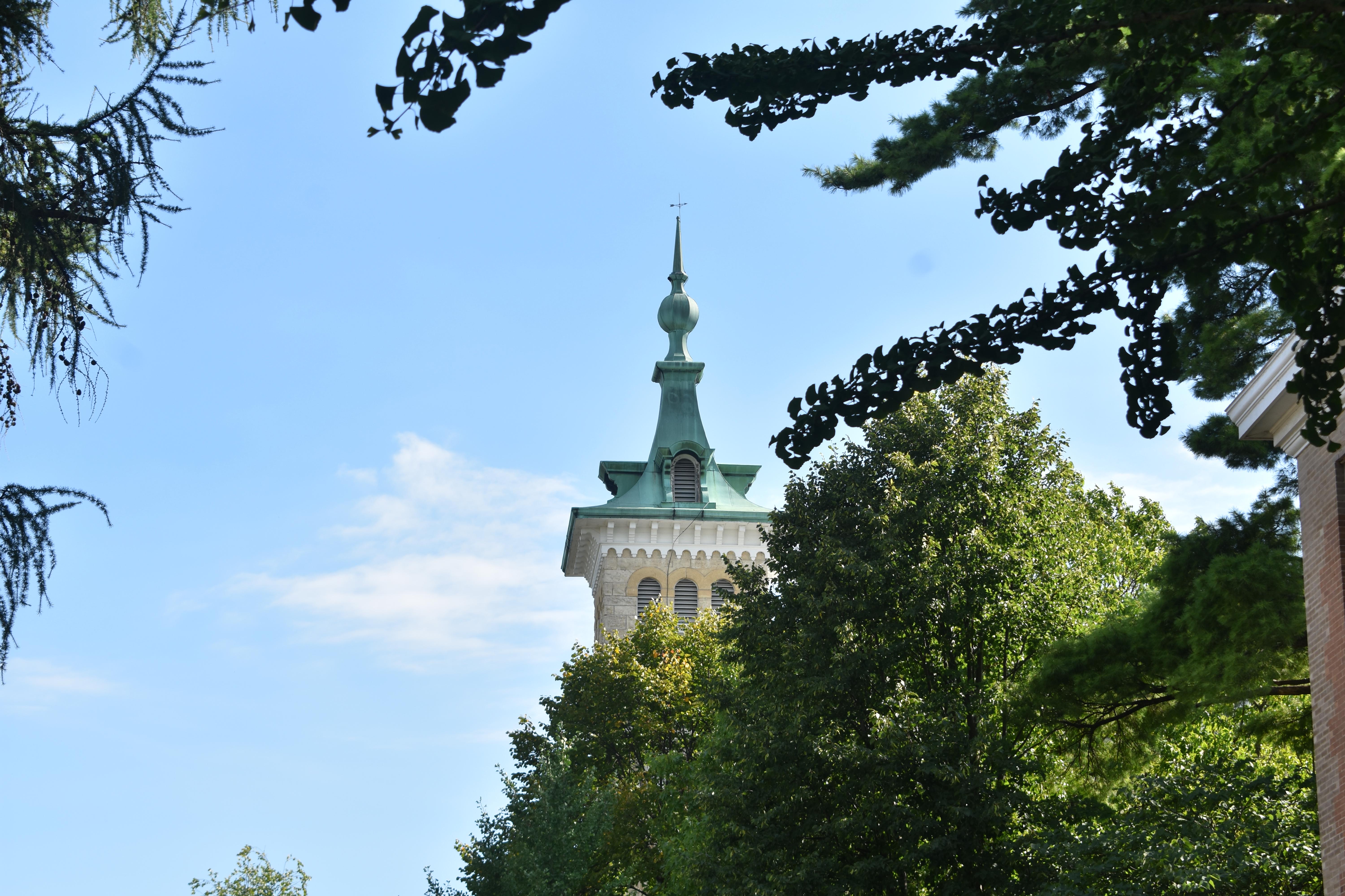 Old Main Tower behind trees